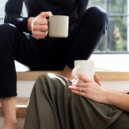 2 people with coffee on their knee