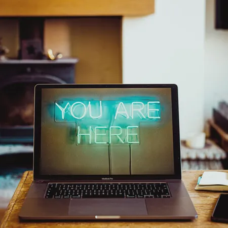 Laptop computer with the screen on and neon graphic
