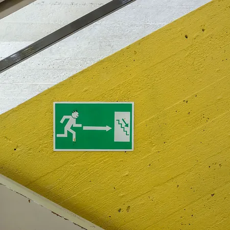Stark shapes with yellow and white stripes and an exit sign