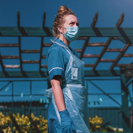 female nurse wearing a ppe face mask