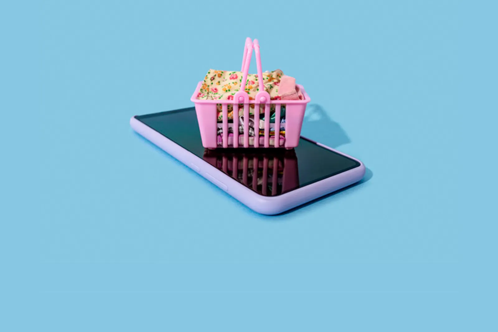 a small shopping basket on top of a mobile phone
