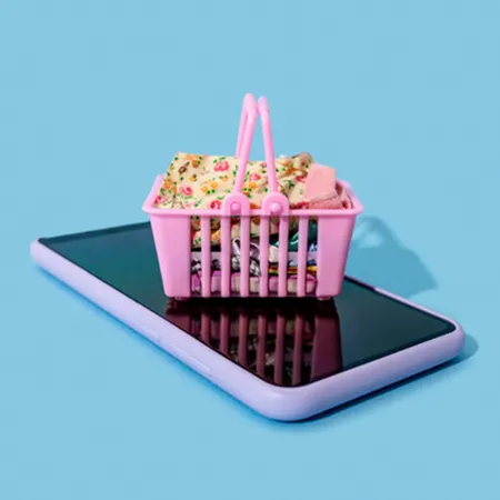 a small shopping basket on top of a mobile phone