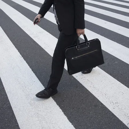 business man walking on a zebra crossing