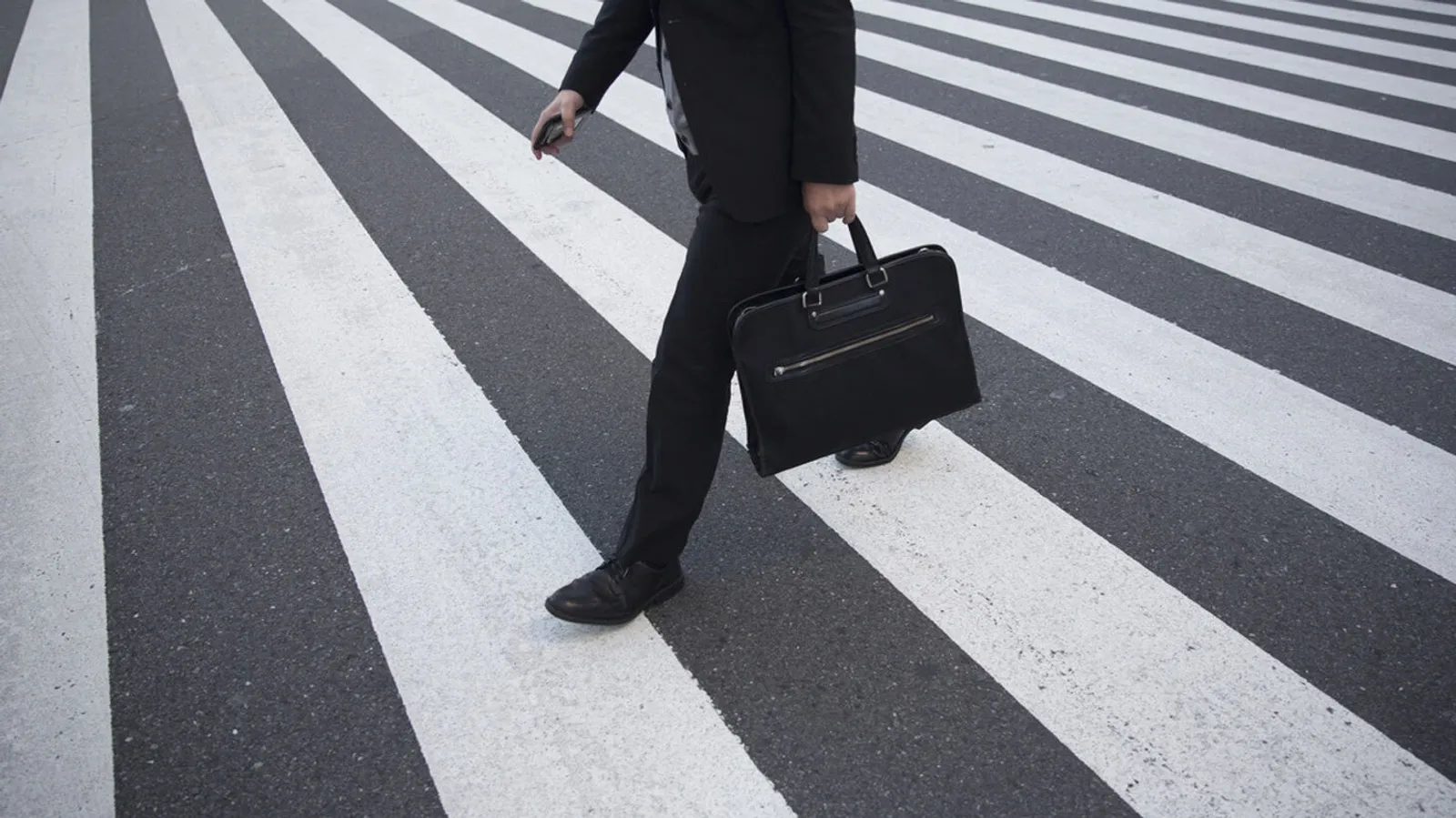 business man walking on a zebra crossing