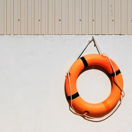 cream dock with bright orange life ring