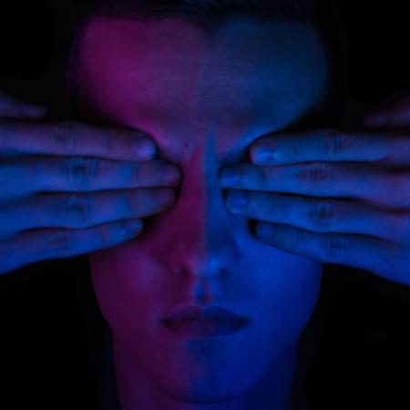 Man covering his eyes.