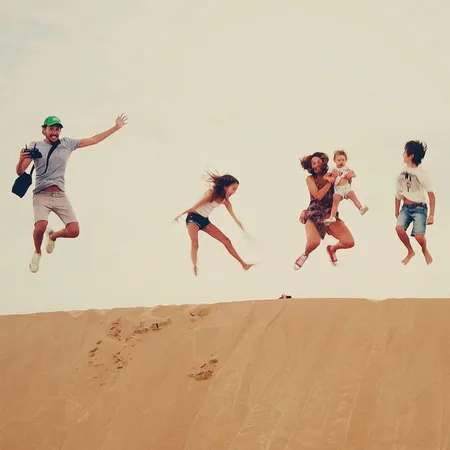 family jump with jumps in the sand dune