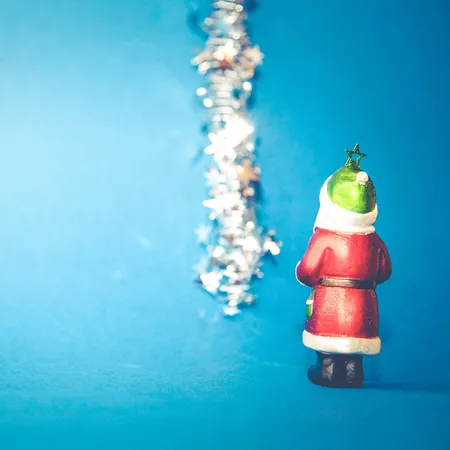 father christmas blue background with tinsel