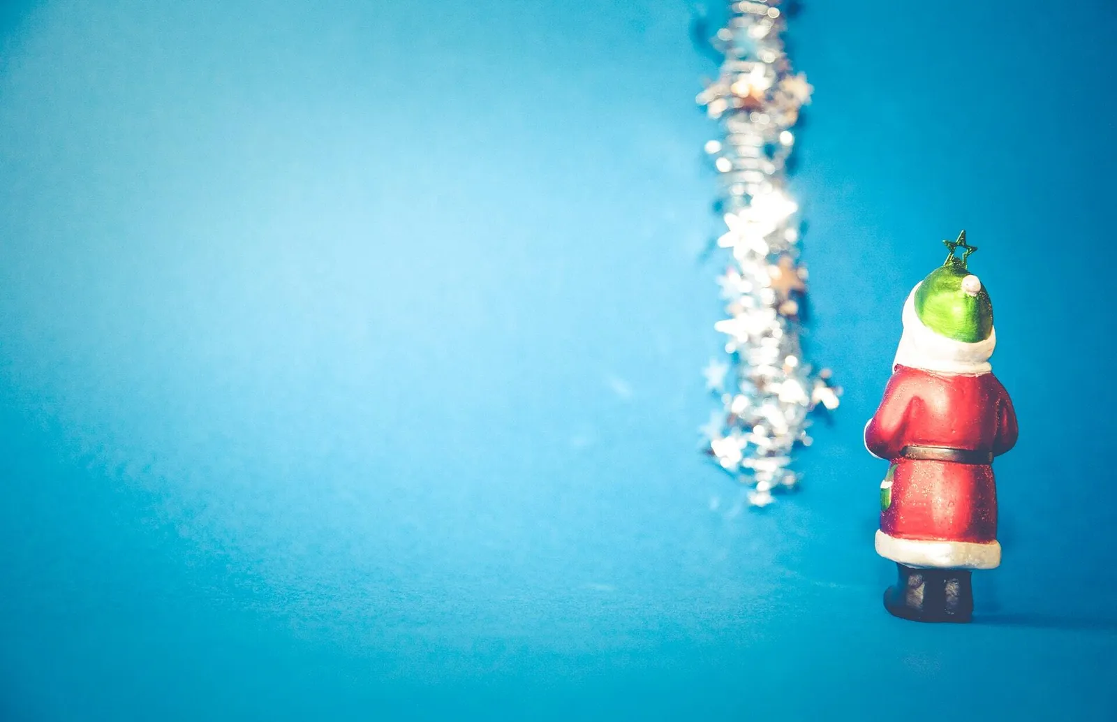 father christmas blue background with tinsel