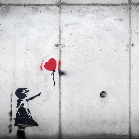 Gray wall with a silhouette of a girl losing a red balloon