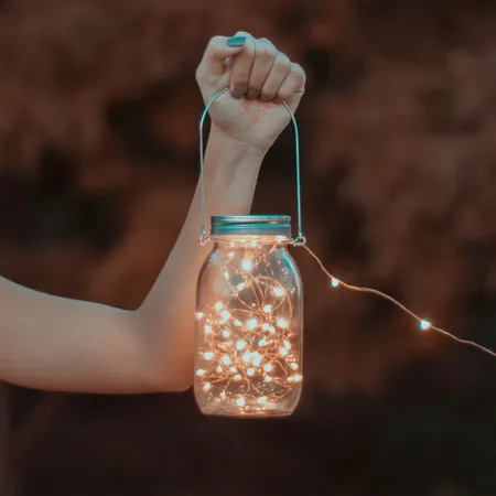 hand-holding-lamp-with-fairy-lights