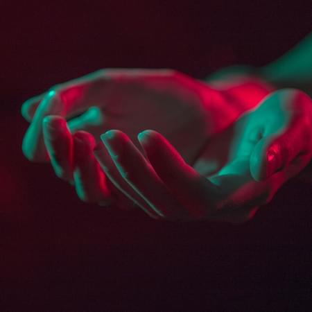 red and green lights with hands heldtogether