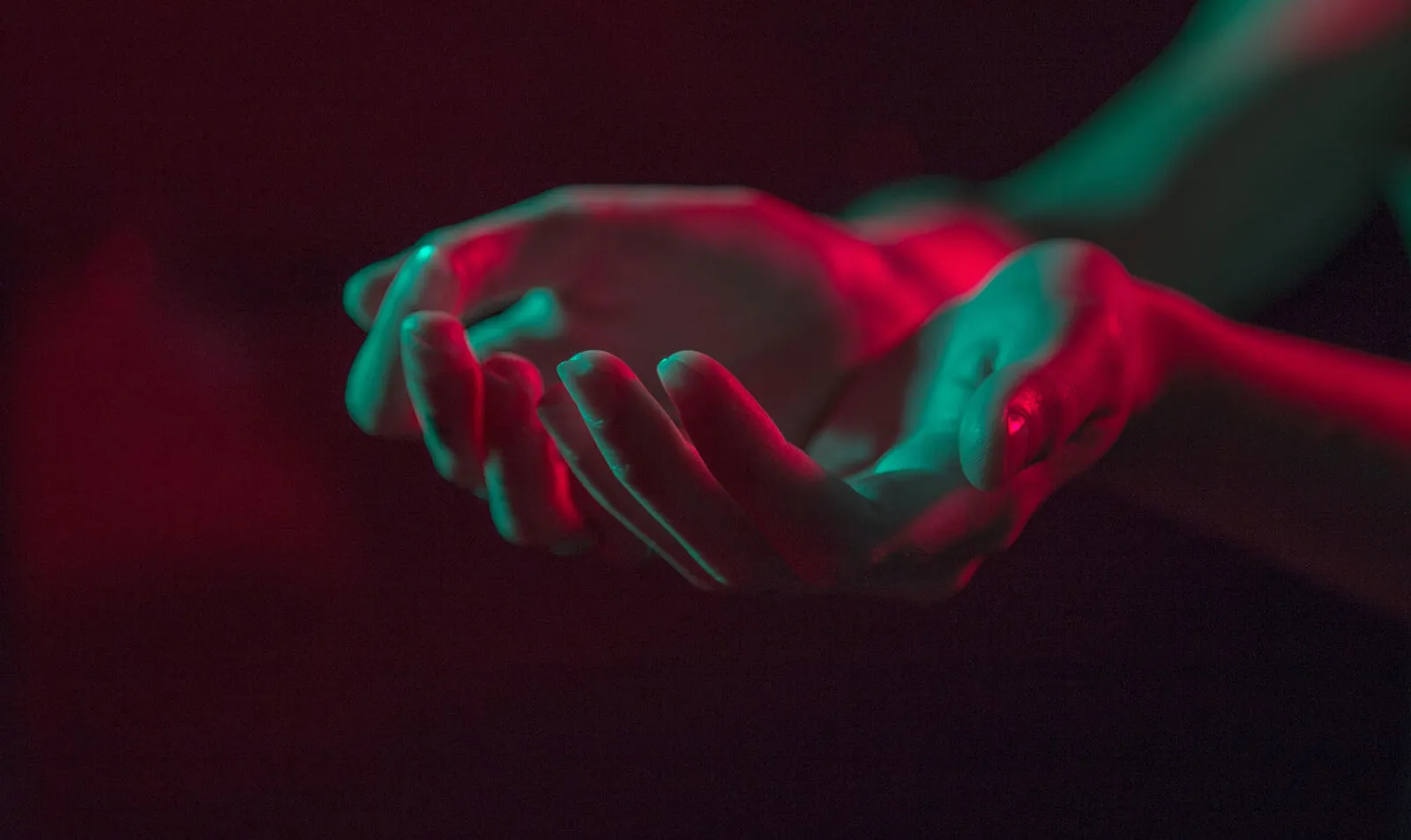red and green lights with hands heldtogether