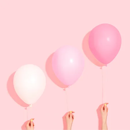 three balloons on a pink background with shades of pink
