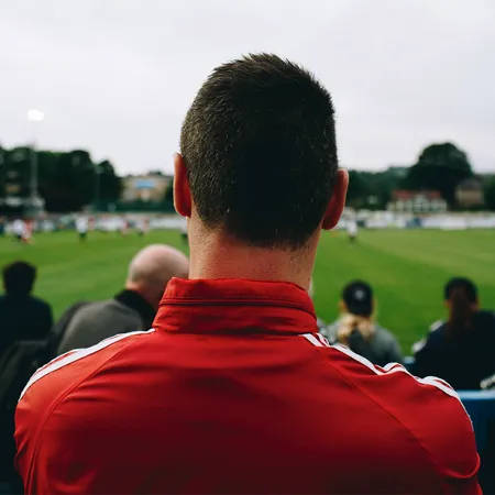 Fan watching a football game.