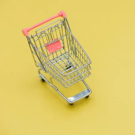 toy shopping trolley on yellow background