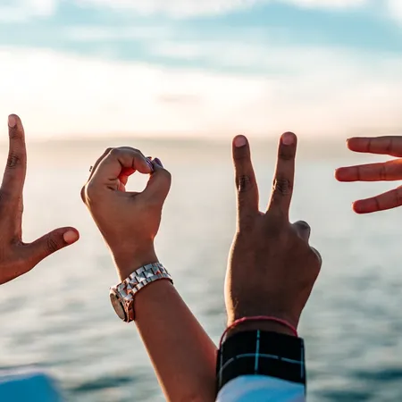 two people forming love with their hands